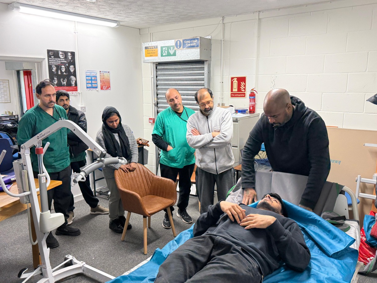 Warren Homecare staff practising patient hoist techniques during moving and handling training